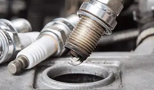 Close up of a spark plug being removed